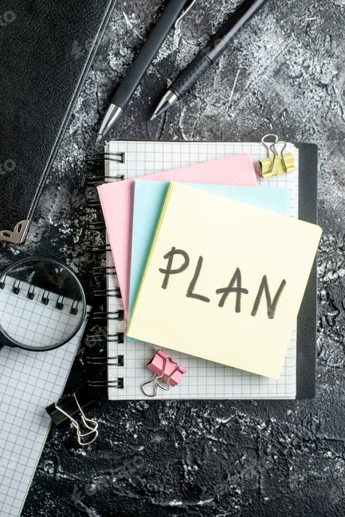 Preview: top view plan written note with colorful stickers on dark gray background student work team office