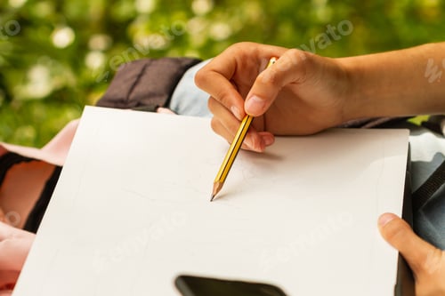 Preview: Hand drawing with pencil in a notebook