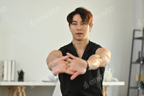 Preview: Shot of male athlete in fitness clothes doing stretching exercise, preparing for morning workout.