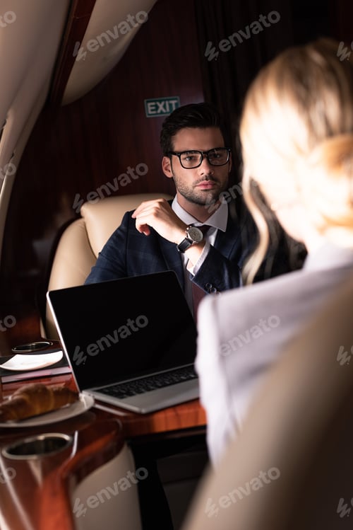 Preview: selective focus on business colleagues in plane