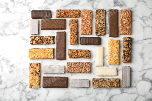Preview: Flat lay composition with protein bars on marble background