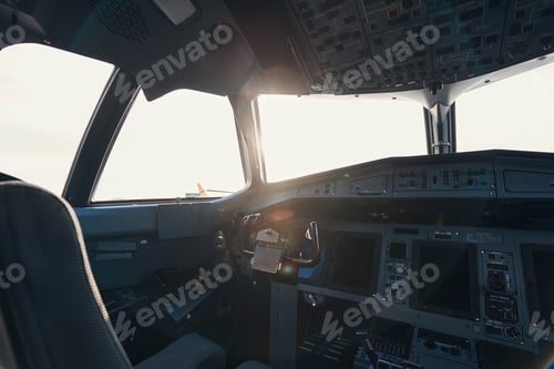 Preview: Empty airplane cockpit with sun shining through window