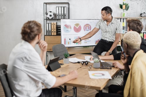 Preview: Group of four multi ethnic partners sitting at desk and listening speech of african american man
