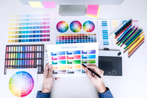 Preview: Male creative graphic designer working on color selection and color swatches