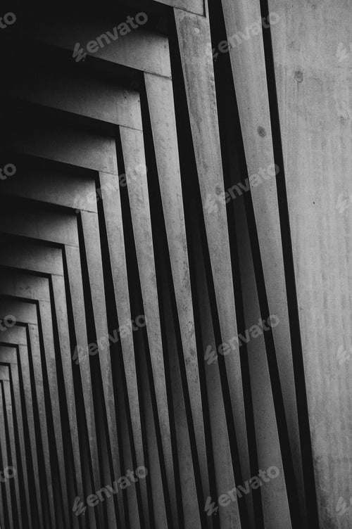 Preview: Vertical grayscale shot of an array of wooden pillars