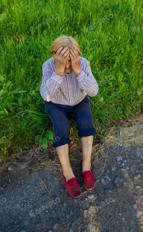 Preview: Old woman feels bad on the street, headache. Selective focus.