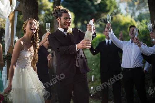 Preview: Groom opening champagne bottle at park