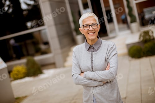 Preview: Smiling Woman with Glasses Outside Office Building