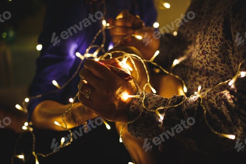 Preview: Yellow luminous garland in the hands
