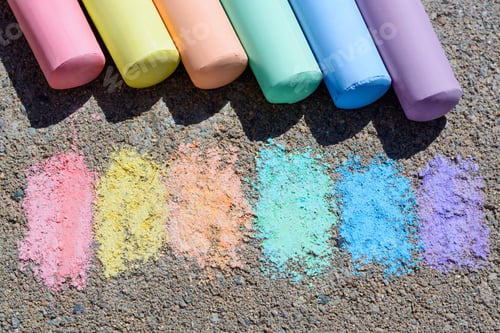 Preview: Colorful chalk sticks and strokes on asphalt outdoors, above view