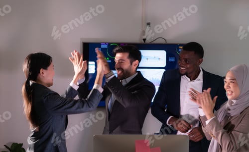 Preview: Group of business people discussing the charts and graphs showing the results of their successful