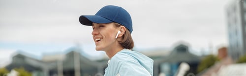 Preview: Young healthy sporty woman using cell telephone during rest after jog