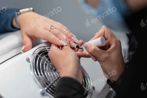 Preview: Girl doing manicure, close-up. Hand and nail care