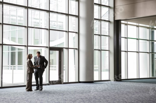 Preview: Woman and man in a meeting in a convention center lobby.