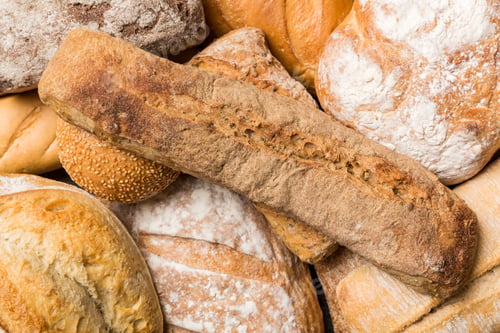 Preview: Homemade natural breads. Different kinds of fresh bread as background, top view with copy space
