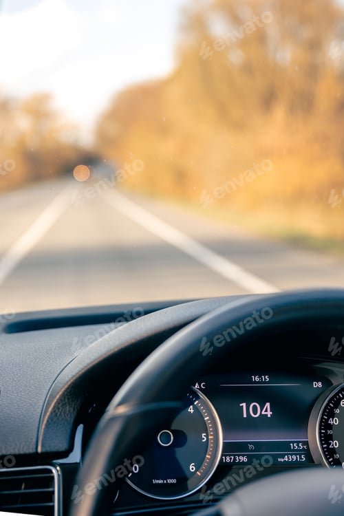 Preview: Steering wheel in a car close up, high speed driving on the road.