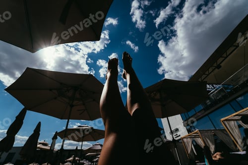 Preview: close up portrait legs of beautiful girl in bikini on the beach