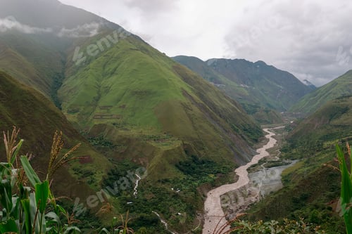 Preview: River winds through the andes mountains in peru, with green valleys and fluffy clouds