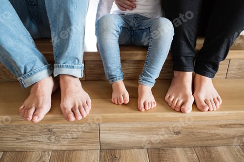 Preview: Beautiful young family. Bare feet of mother, father and daughter