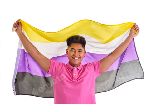Preview: non binary asian person smiling in pink shirt holding non-binary gender flag on white background