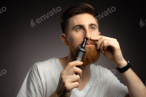 Preview: Man Grooming with Nose Hair Trimmer at Home