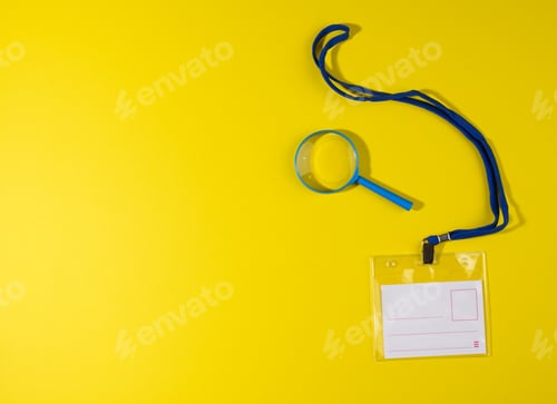 Preview: Transparent plastic badge on a blue lanyard on a yellow background