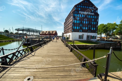 Preview: KLAIPEDA, LITHUANIA-AUGUST 16, 2017: Old Mill Hotel on the Dane River embankment in the old town of
