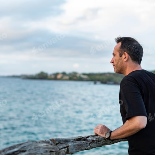 Preview: Handsome man looking into the sea in a Hawaiian island.
