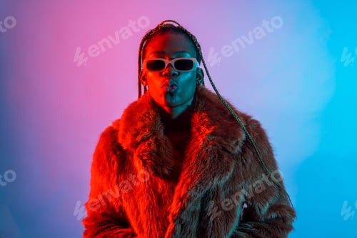 Preview: Black ethnic woman with braids with red and blue led lights, studio shoot
