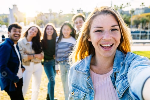 Preview: Happy group of young friends having fun taking selfie portrait together outdoors