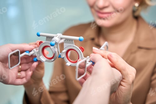 Preview: Employee of an optical salon uses professional device at work