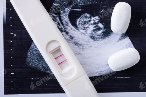 Preview: close up of pills and pregnancy test on ultrasound image