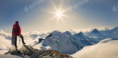 Preview: Panoramic view of male climber looking out from snow covered mountain top, Swiss Alps, Switzerland