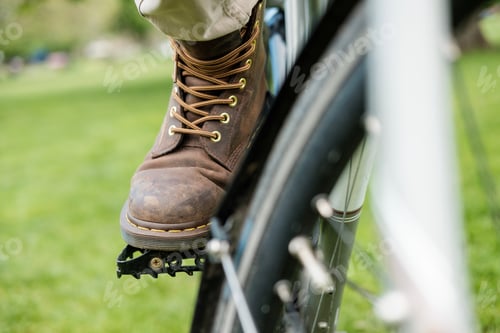 Preview: Close-up of leather boot on pedal bike.