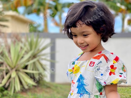 Preview: Kid smiling standing in the garden