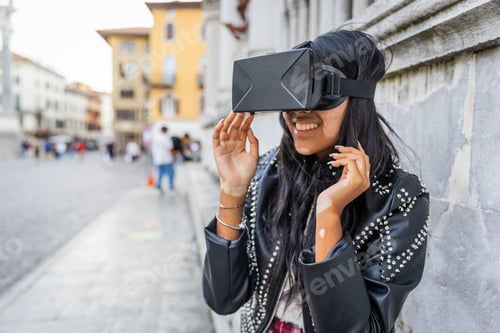 Preview: A girl uses virtual reality headsets and has fun while outdoors in the city
