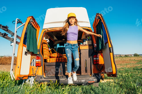 Preview: The happy girl has fun on a wonderful camping day. Van life concept.