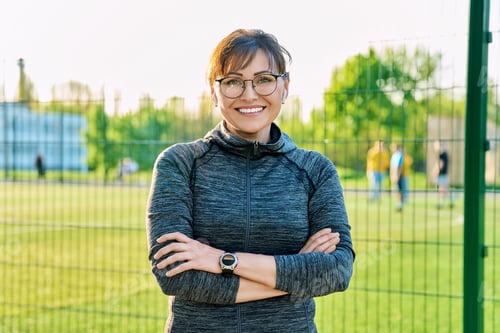 Preview: Outdoor portrait of active smiling middle aged woman looking at camera