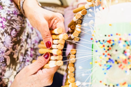 Preview: Top view shot of a woman working with weaving bobbins