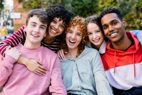 Preview: College student friends smiling at camera posing for a group portrait at campus.