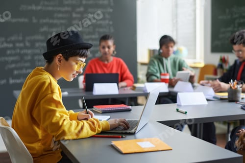 Preview: Side View Teen Female Student using Computer during Lesson