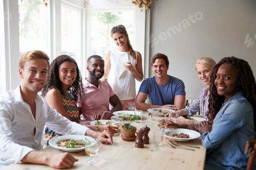Preview: Portrait Of Friends Sitting At Table In Restaurant Enjoying Meal Together