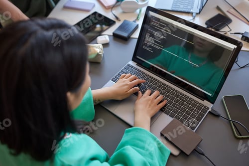 Preview: Focus on hands of young female student typing on laptop keyboard