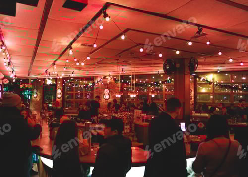 Crowded beautifully lit bar in Chicago, with hanging festive lights