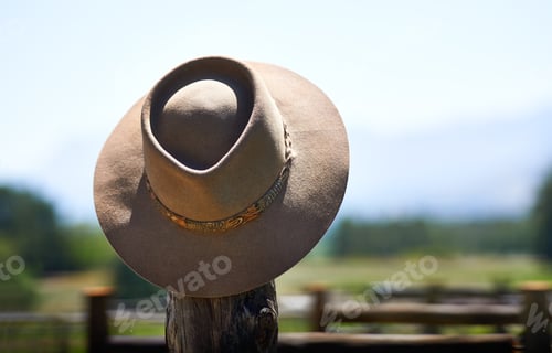 Preview: Hats off to you. Shot of a wide brimmed hat on a fence post.