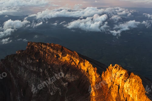 Preview: Crater rim of mount Agung in Bali at sunrise summit. Above the clouds, colorful landscape