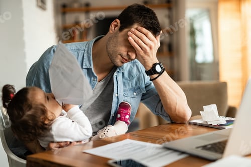 Preview: Stay at home father having a headache while babysitting and working at home.