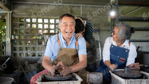 Preview: Portrait of a senior Asian couple doing activities together in the pottery workshop.