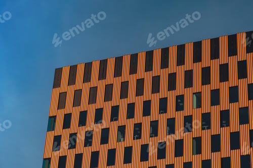Preview: Modern office building exterior with glass facade on clear sky background. Transparent glass wall of