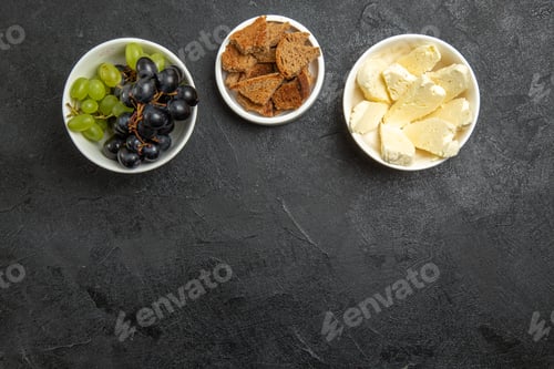 Preview: top view fresh mellow grapes with bread and cheese on dark background food meal milk fruit